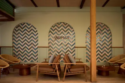 a table with two surfboards and two pairs of shoes at Kimpton Las Mercedes by IHG in Santo Domingo