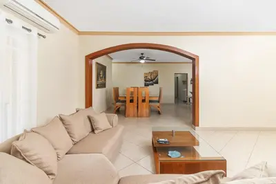 a living room with a couch and a table at Luxe Comfort 8 Bedroom Villa with Private Pool & Entertainment in Sosúa