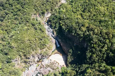 an aerial view of a river in a forest at NOMAD Domes Sky Watching at Jarabacoa in Jarabacoa