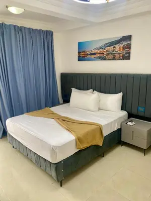a bedroom with a large bed with blue curtains at RIG Puerto Malecón in Santo Domingo