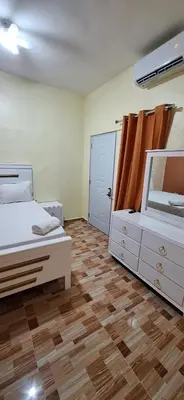 a bedroom with a bed and a dresser and a mirror at Hotel Villa Marchena in Azua de Compostela
