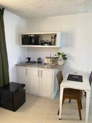 a small kitchen with a sink and a table with a table at Blessed house 