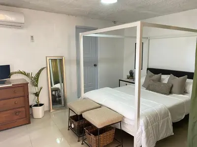 a bedroom with a large white bed and a mirror at Blessed house 