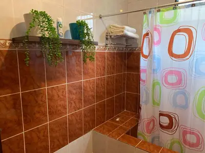 a bathroom with a shower with a shower curtain at Residencia Katya in La Romana