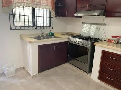 a kitchen with a stove and a sink at Residencia Katya in La Romana