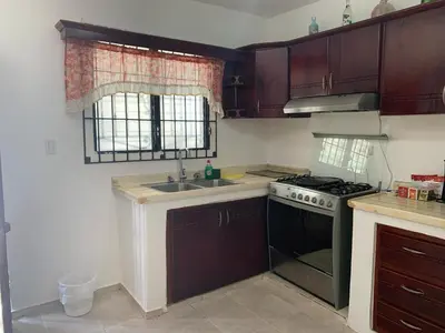 a kitchen with a stove and a sink at Residencia Katya in La Romana
