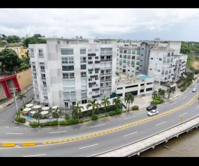 a large building with a road in front of it at Apartamento Riviera Colonial, Santo Domingo in Calero