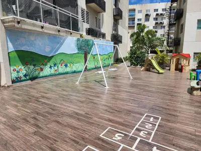 a mural on the side of a building with a playground at Apartamento Riviera Colonial, Santo Domingo in Calero