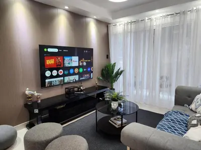 a living room with a large flat screen tv at Apartamento Riviera Colonial, Santo Domingo in Calero