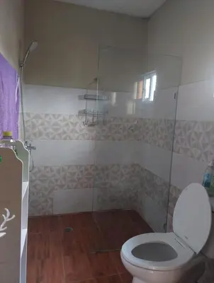a bathroom with a toilet and a glass shower at New apartment close to everything in Santiago de los Caballeros