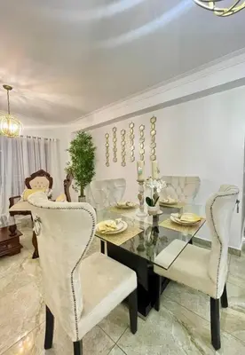 a dining room with a glass table and chairs at Super Cozy n´Confortable apart. in Ensanche Los Minas