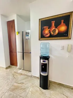 a water dispenser in a room with vases on the wall at Super Cozy n´Confortable apart. in Ensanche Los Minas