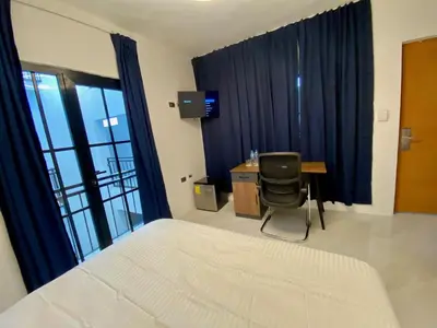 a bedroom with a bed and a desk and a chair at RIG Colonial Experience in Santo Domingo