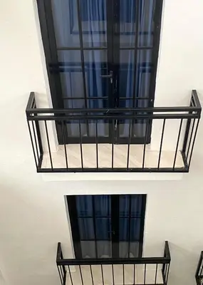 a balcony with black metal railings and a window at RIG Colonial Experience in Santo Domingo