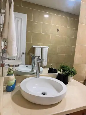 a bathroom with a white sink and a mirror at Acogedor Apartamento remodelado in Sosúa