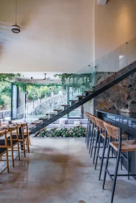 a staircase in a restaurant with chairs and tables at Casa Ataraxia Modern Luxe Villa in Las Terrenas