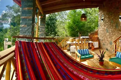 a hammock on a porch of a house at Villa Tortuga Constanza in Constanza