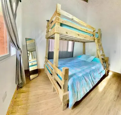 a wooden bunk bed in a room with a mirror at Villa Tortuga Constanza in Constanza