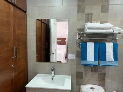 a bathroom with a sink and a mirror and towels at Luxury Beach Front Villa with Private pool and stunning Ocean View! in Punta Rucia
