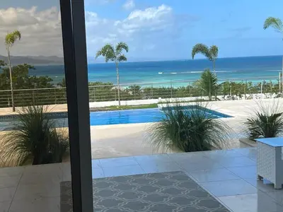 a view of a swimming pool from a window at Luxury Beach Front Villa with Private pool and stunning Ocean View! in Punta Rucia
