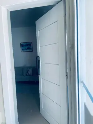 a door leading into a room with a couch at A Caribbean-style rebirth, 2 minutes from the beach in La Romana