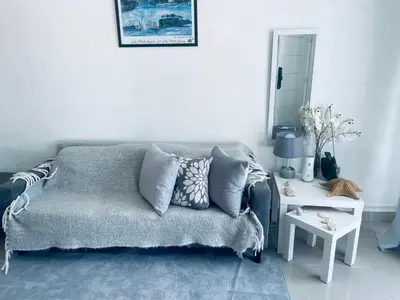 a living room with a couch and a table at A Caribbean-style rebirth, 2 minutes from the beach in La Romana