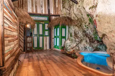a room with a bath tub in a room with a tree at Casa El Paraiso, Eco Lodge in Santa Bárbara de Samaná