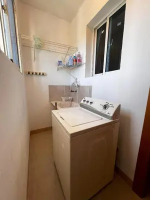 a washer and dryer in a small kitchen at Bello Apartamento en Santiago con todas las comodidades in Santiago de los Caballeros