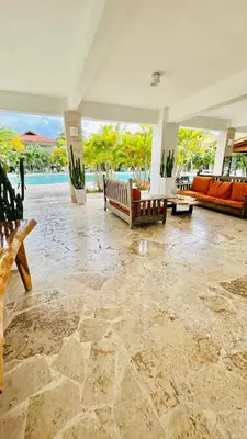 a living room with couches and a pool at Bayahibe Paraíso in Bayahibe