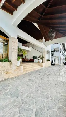a building with a stone floor and a large patio at Bayahibe Paraíso in Bayahibe
