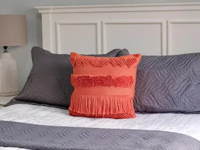 a red pillow sitting on top of a bed at Apartamento de Ensueño en Las Terrenas Penthouse in Las Terrenas