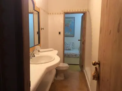 a bathroom with a sink and a toilet and a mirror at Caraibidamari in Bayahibe