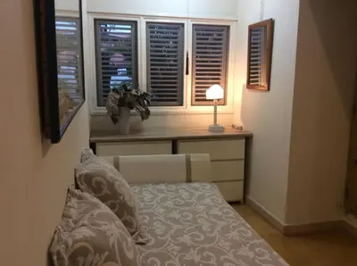 a bedroom with a bed and a desk with windows at Caraibidamari in Bayahibe