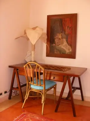 a wooden desk with a chair and a lamp at Caraibidamari in Bayahibe
