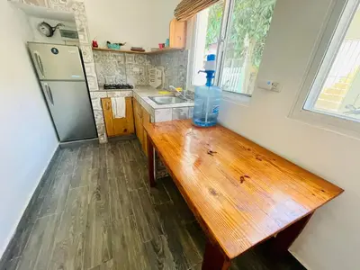 a bottle of water sitting on a wooden table in a kitchen at Mango House. Mono 2 bedrooms in Cabarete