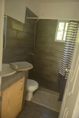 a bathroom with a toilet and a sink and a shower at Mango House. Mono 2 bedrooms in Cabarete