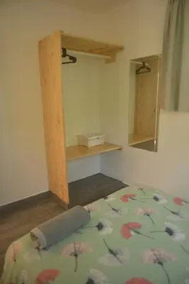 a bedroom with a bed with a flower pattern on it at Mango House. Mono 2 bedrooms in Cabarete