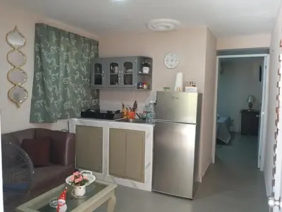 a kitchen with a refrigerator and a living room at Villa rozenuda in El Higo