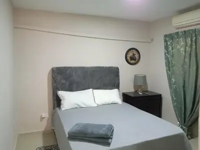 a bedroom with a bed and a clock on the wall at Villa rozenuda in El Higo