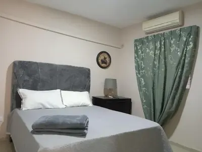 a bedroom with a bed with a green curtain at Villa rozenuda in Boca Chica
