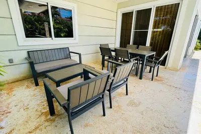 a group of benches and tables on a porch at Casa Linda Villa 920 - Sosua in Sosúa
