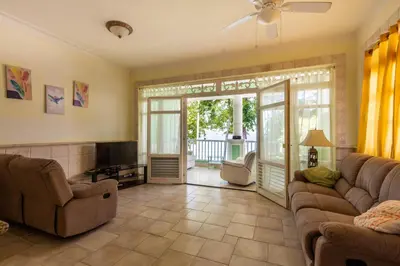 a living room with a couch and a tv and a sliding glass door at 