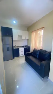 a living room with a couch and a kitchen at Estefany Aparment New in San Felipe de Puerto Plata
