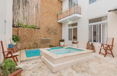 a swimming pool in the backyard of a building at Enriquillo 2-Bedroom Apt Casa Areito in Santo Domingo