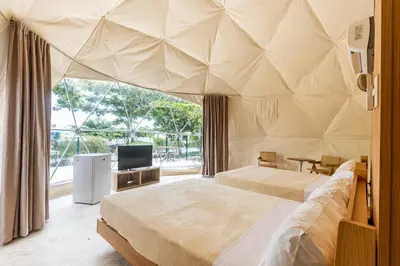 a large bedroom with two beds and a tv at Bubble Glamping Sosua! in Sosúa