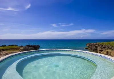 a hot tub with the ocean in the background at Bubble Glamping Sosua! in Sosúa