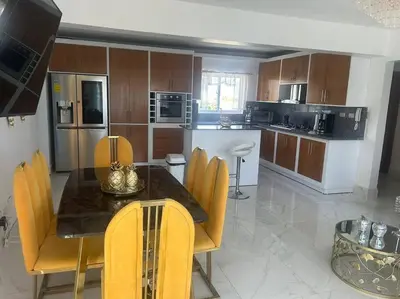 a kitchen with a table and chairs in a room at Acogedor Sweet Apartament in Santiago de los Caballeros