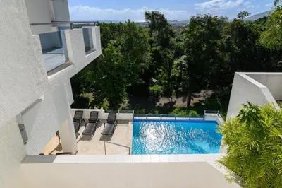 a view of a swimming pool from a house at Mango y Jobo - Relaxed Mountain & Sea Panoramic view - 10mins drive to beach and city in San Felipe de Puerto Plata