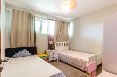 a small bedroom with two beds and a window at Infiniti Blu, Sosua in Sosúa