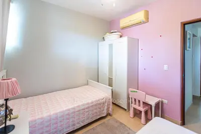 a small bedroom with a bed and a table at Infiniti Blu, Sosua in Sosúa